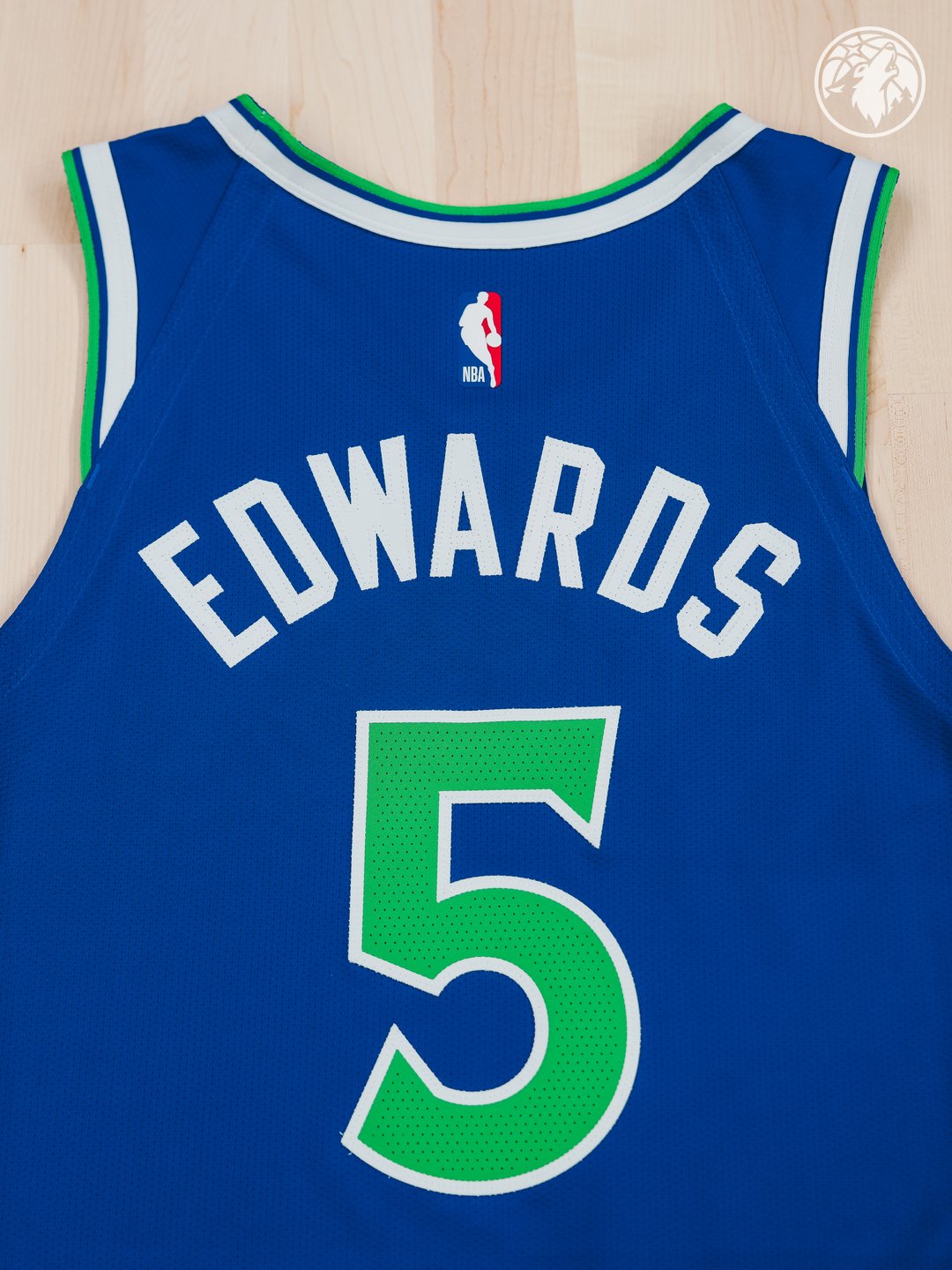 Minnesota Timberwolves new Icon Edition blue road jersey 2026-27 laid flat back product shot showing Anthony Edwards EDWARDS nameplate in white and the bright green number five in massive scale across the jersey back, the bright green numerals one of the standout design details of the entire Wolves rebrand