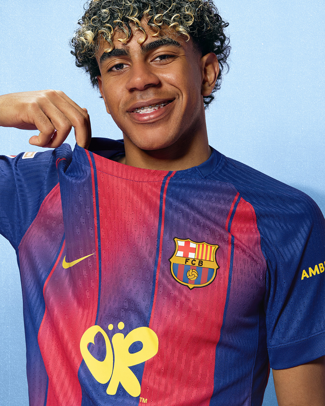 Lamine Yamal modeling the FC Barcelona Olivia Rodrigo El Clasico kit with the yellow butterfly logo on the front of the Nike home jersey