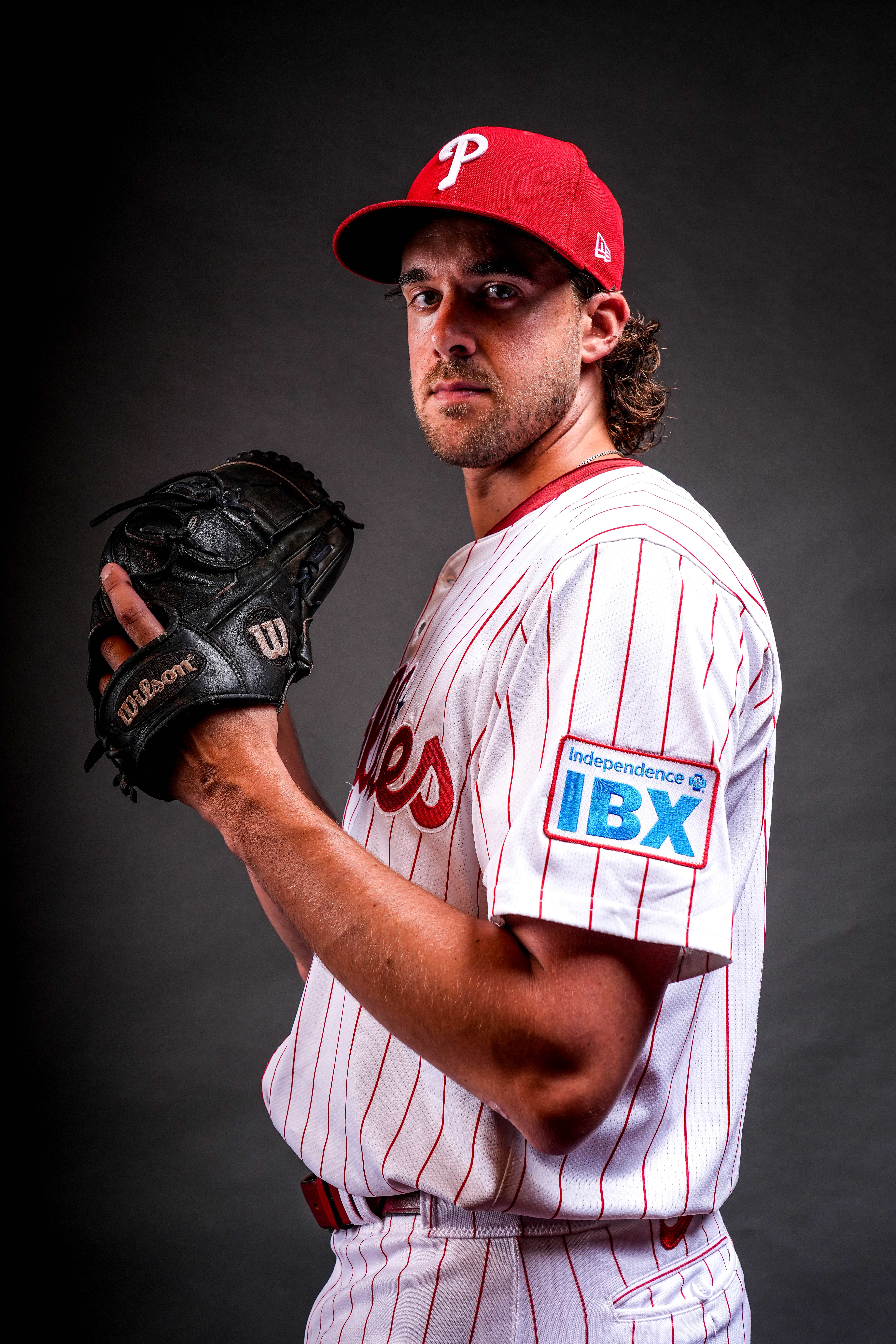 Phillies pitcher wearing red pinstripe home jersey with IBX patch