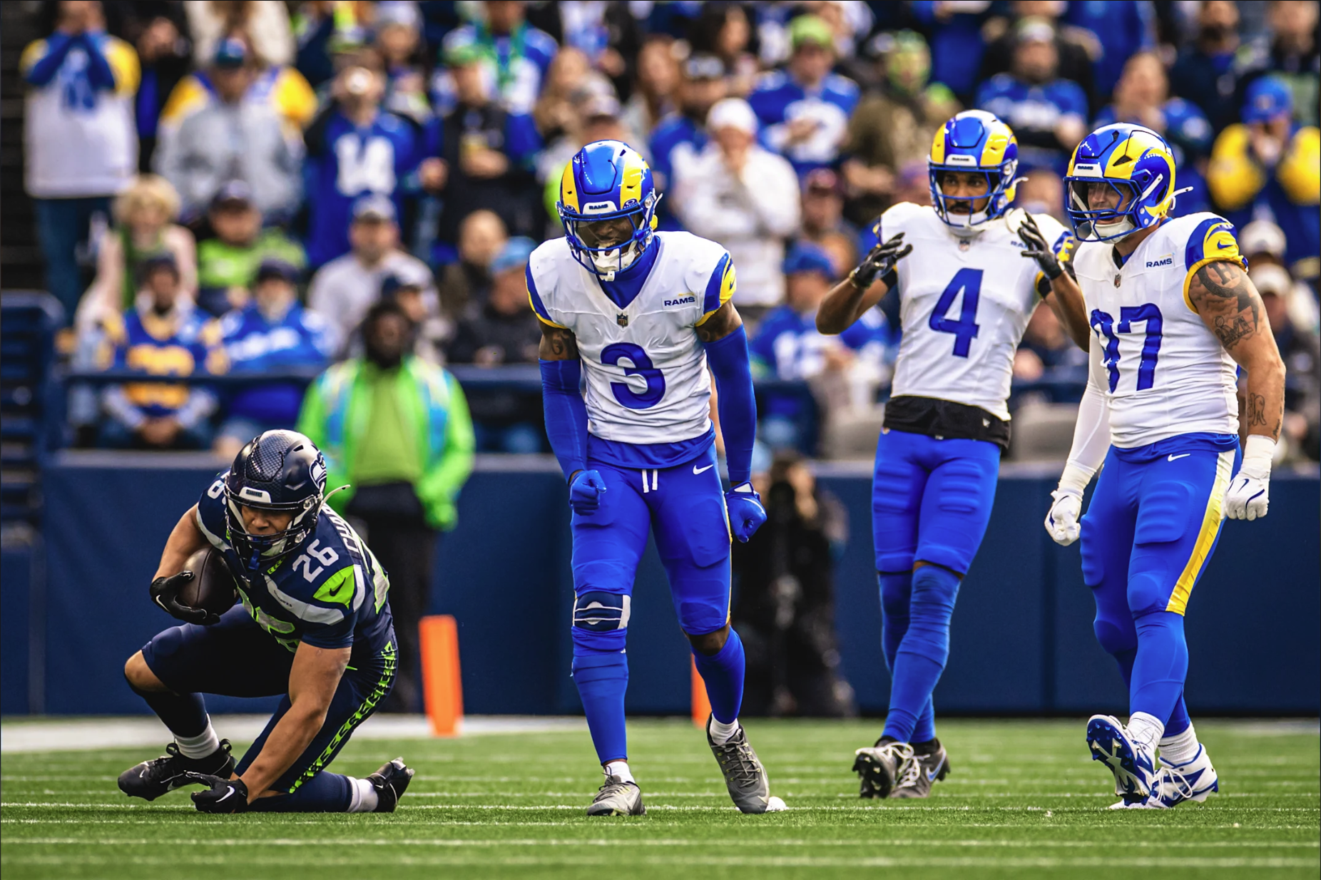 Los Angeles Rams players in white away jerseys with blue pants against Seattle Seahawks