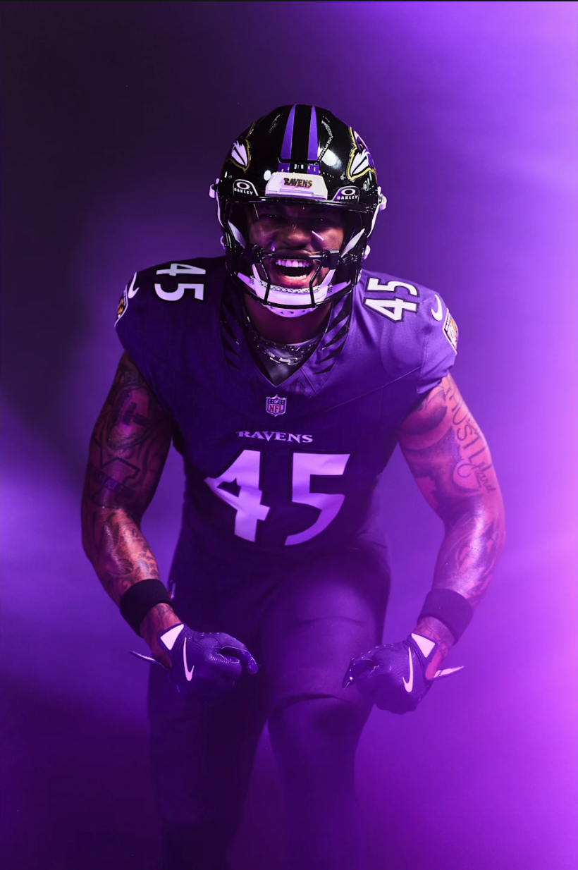 Baltimore Ravens 2026 primary home purple uniform player portrait with black helmet and new Raven Wings collar pattern