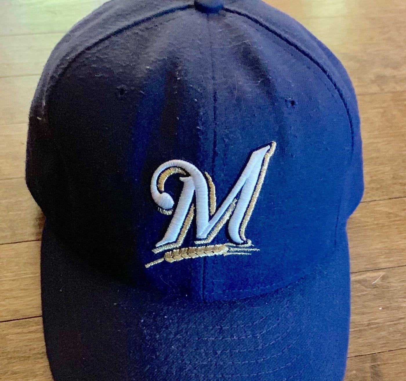 A navy Brewers cap with the script M and barley logo used from 2000 to 2019