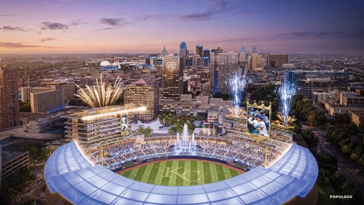 Kansas City Royals new downtown ballpark rendering showing a twilight view of the stadium with fireworks, the Kansas City skyline in the background, and a KC emblem on the field at Crown Center