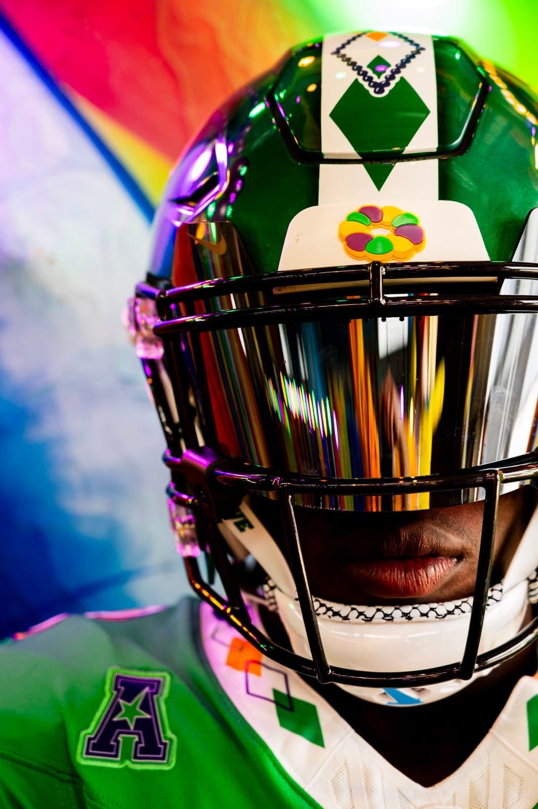 Tulane City Edition Mardi Gras football helmet with green metallic shell, argyle stripe and a king cake baby bumper