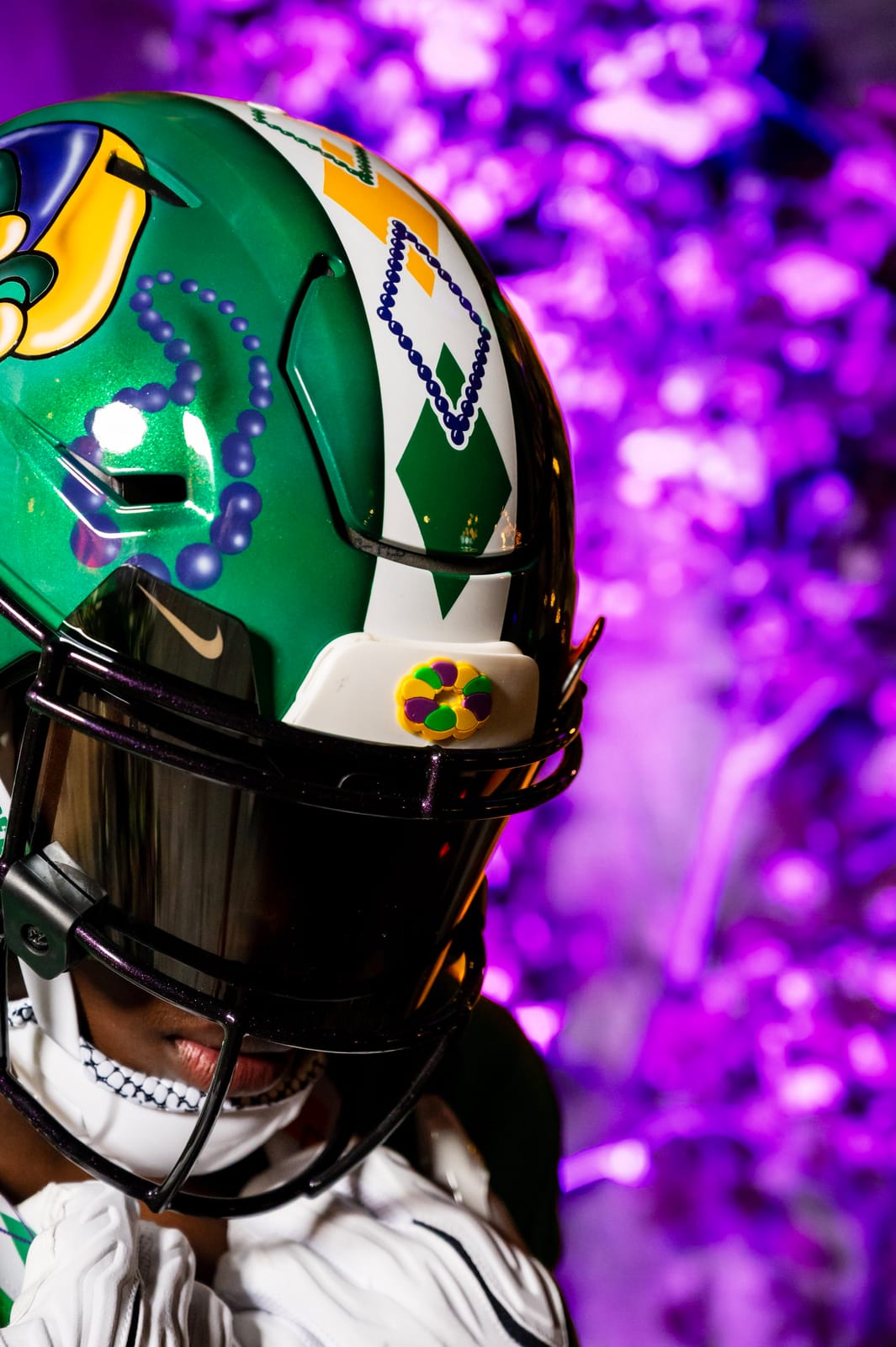 Side view of the Tulane City Edition helmet showing the beaded argyle stripe and metallic green shell