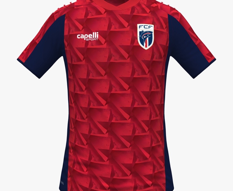 Cape Verde 2026 World Cup red Capelli third jersey with navy side panels, a tonal geometric pattern, and the FCF crest, worn in the Group H match vs Uruguay