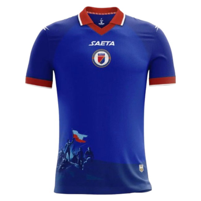 Haiti 2026 World Cup royal blue home jersey with a red collar, the SAETA sponsor, the Haiti crest, and a revolutionary-era flag graphic across the hem, worn in the Group C match vs Morocco