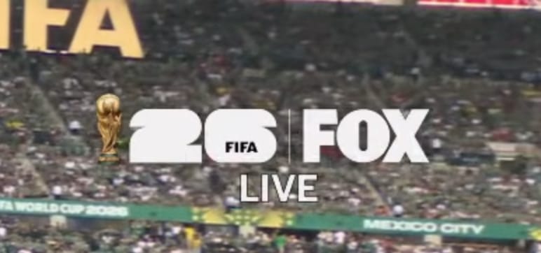 FOX's FIFA World Cup 26 corner logo bug from the 2026 World Cup broadcast showing the golden World Cup trophy next to the FIFA 26 wordmark and the FOX logo with LIVE stacked underneath over the crowd at Estadio Azteca