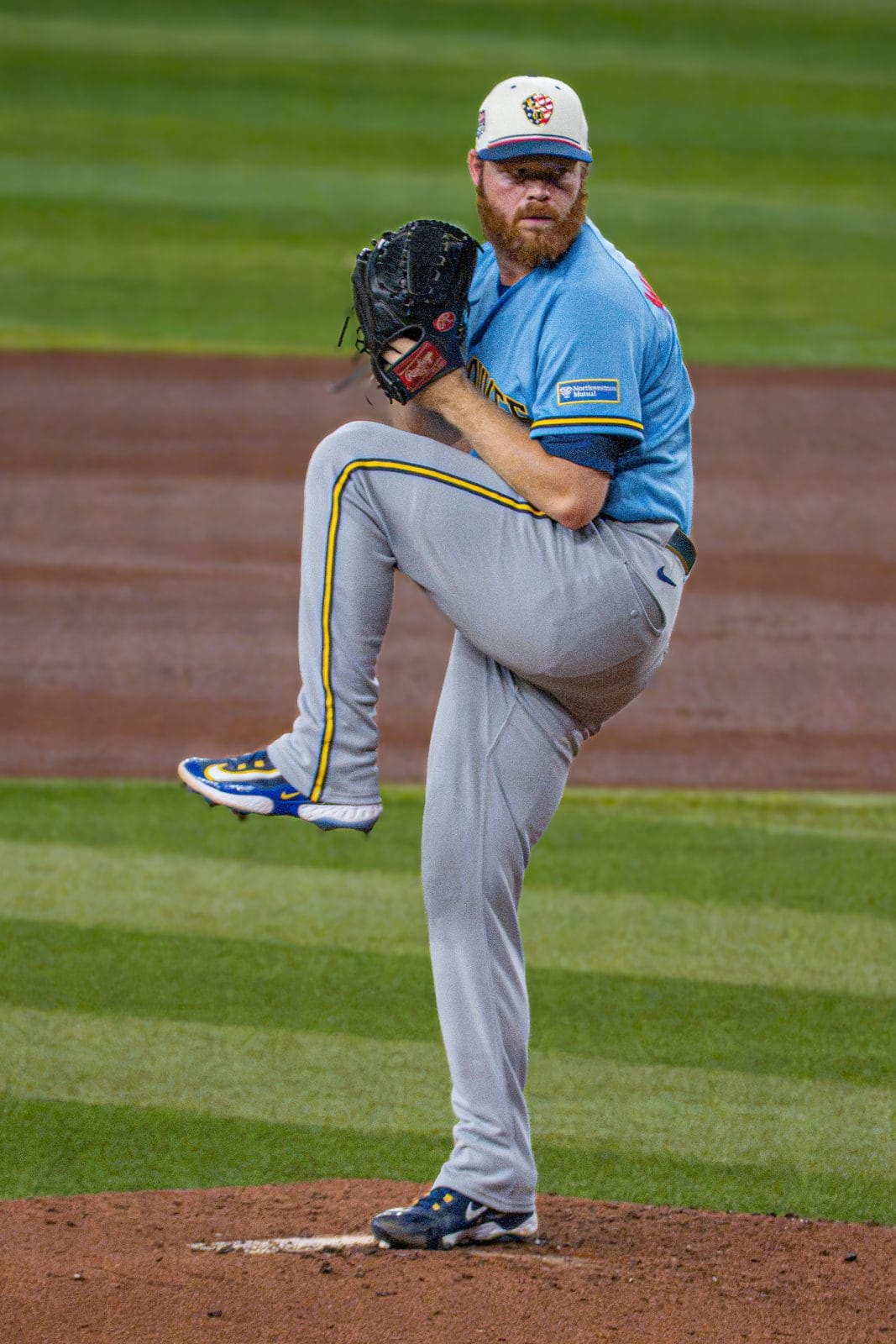 Brewers pitcher Brandon Woodruff in the powder blue road jersey and gray road pants, wearing a July 4 holiday cap, in July 2026